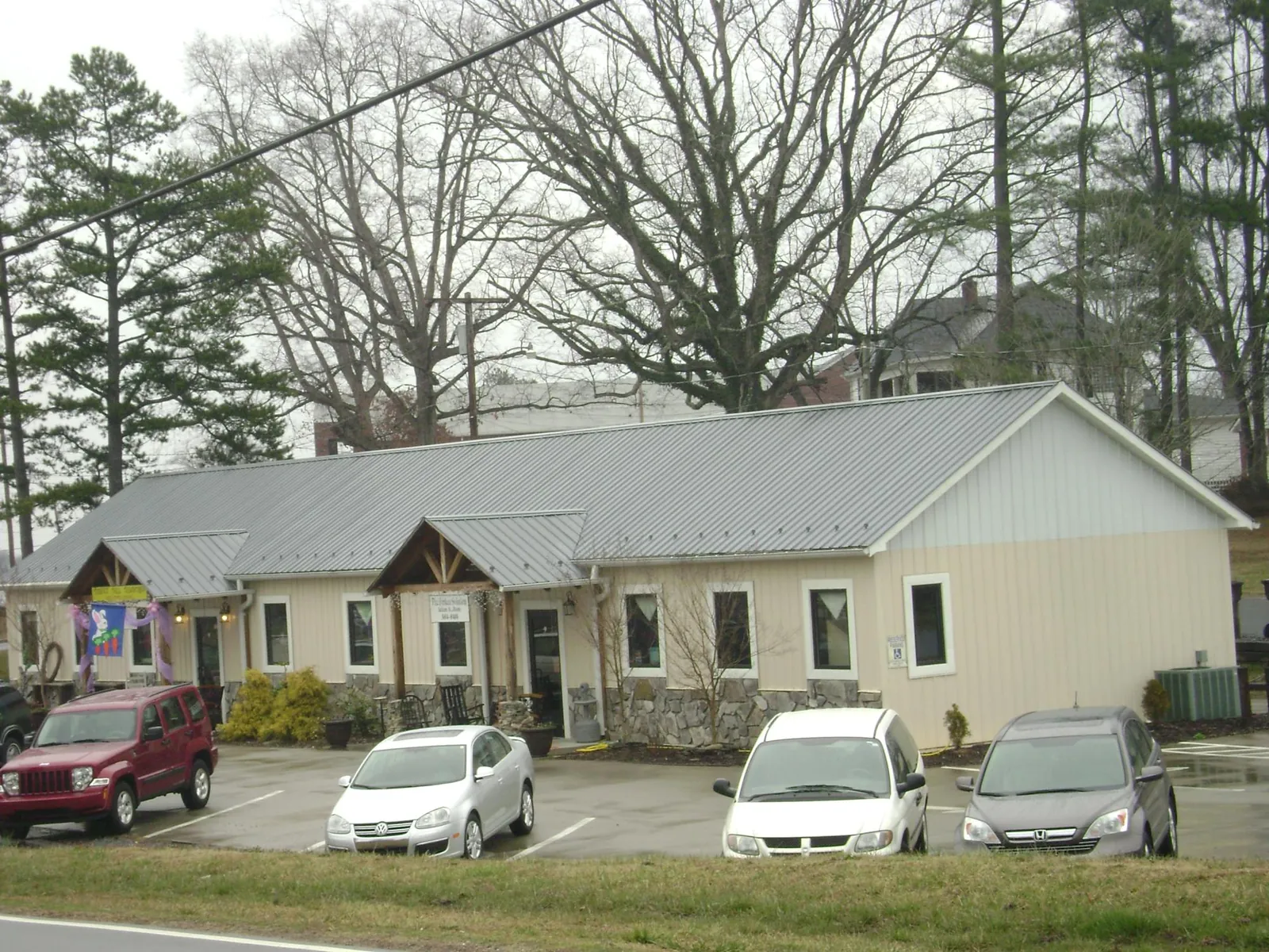 Gray metal roof with timber entry brackets on a small commercial building in Underwood